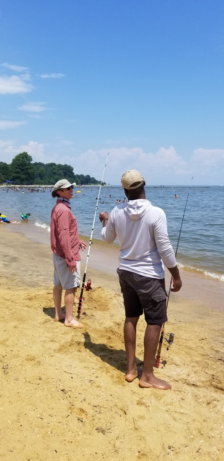 William Storm fishing with another angler along the Chesapeake Bay shoreline